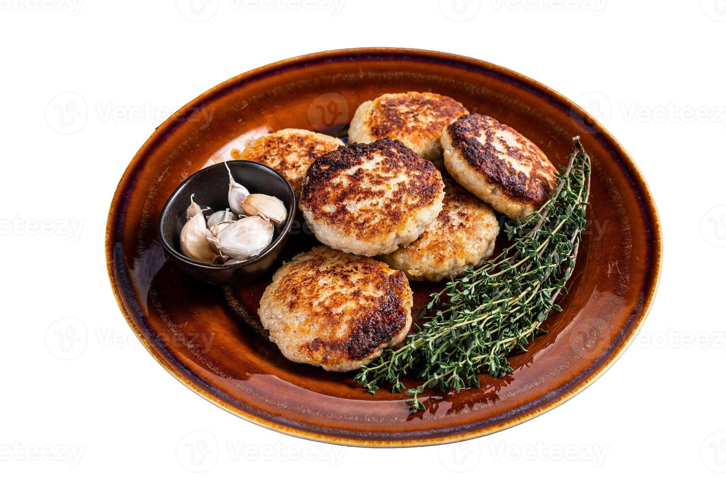 Fried pork and beef meat cutlets or patty in a rustic plate. Isolated on white background. photo