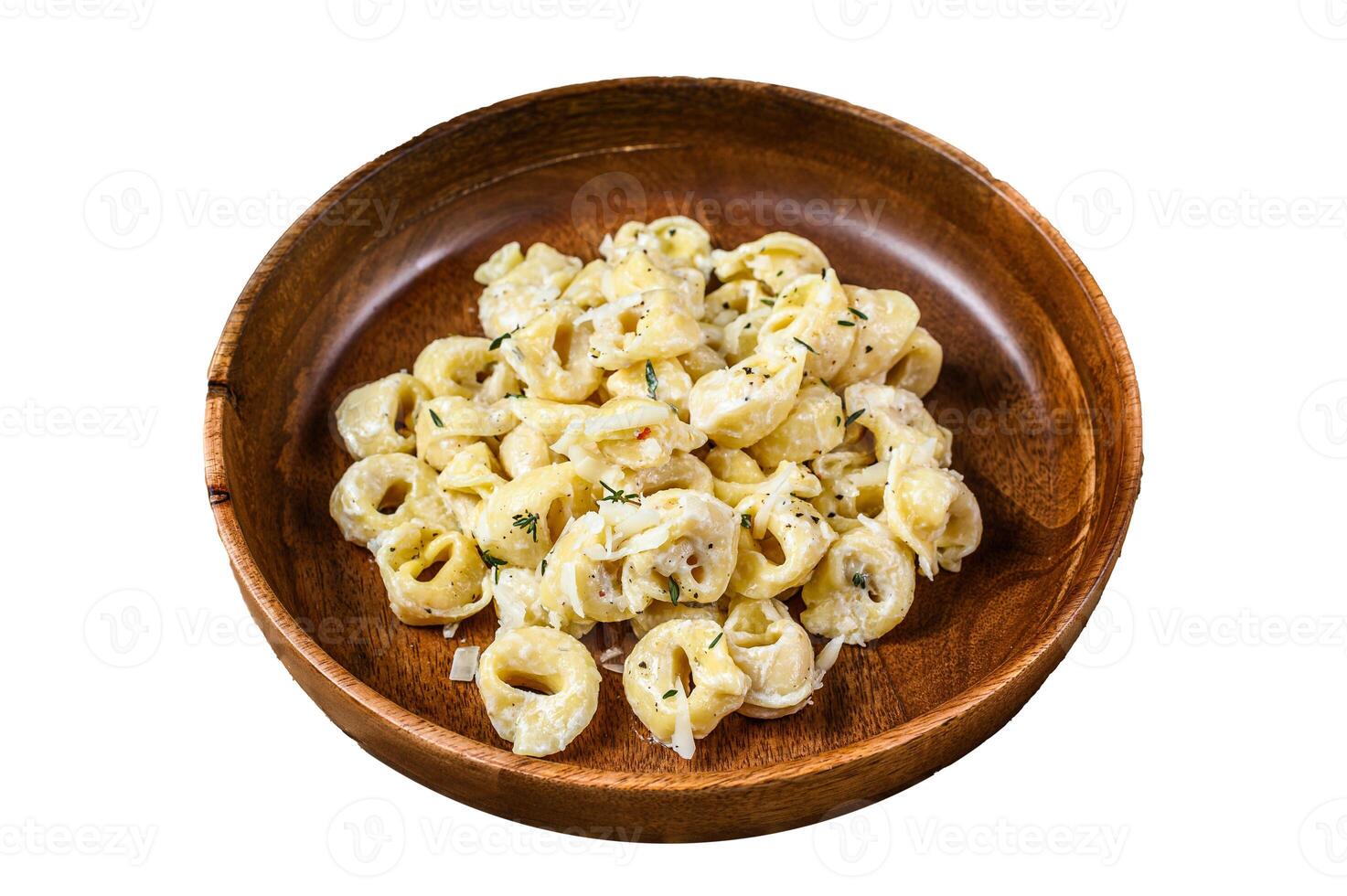 Ravioli or tortellini pasta in cream cheese sauce with meat. Isolated on white background, top view. photo