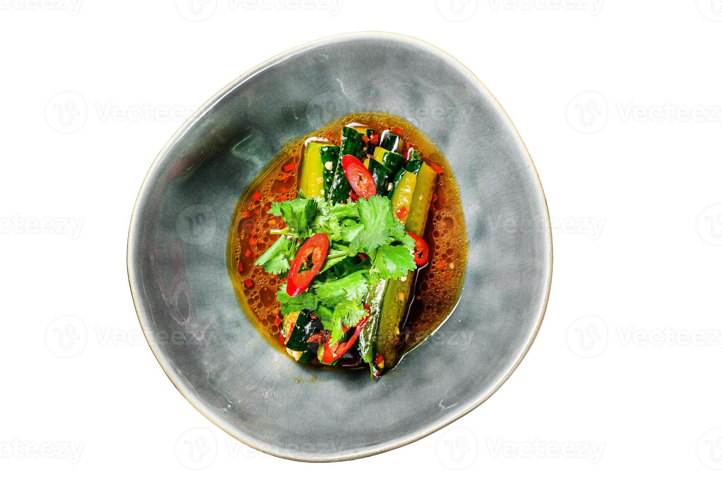 Chinese cucumber salad with chili pepper, garlic, soy sauce and sesame oil Isolated on white background. Top view. photo
