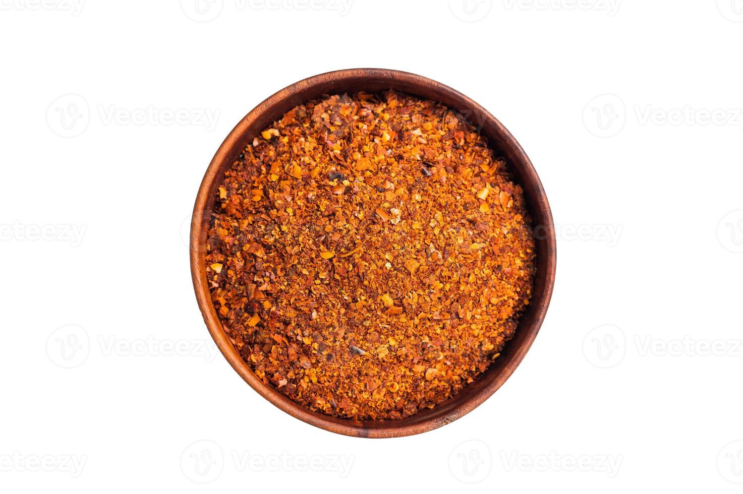 Chili pepper and paprika red flakes in a bowl isolated on white background. top view photo