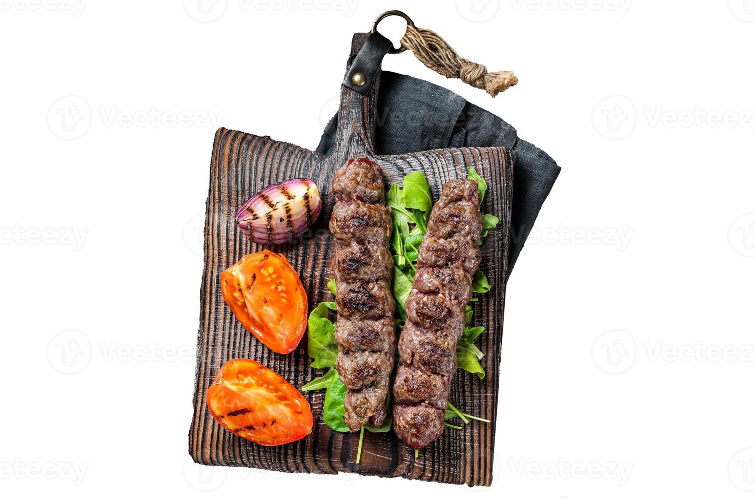 Turkish adana kebab, ground beef and lamb meat grilled on skewers served with tomato, salad and onion. Isolated, white background. photo