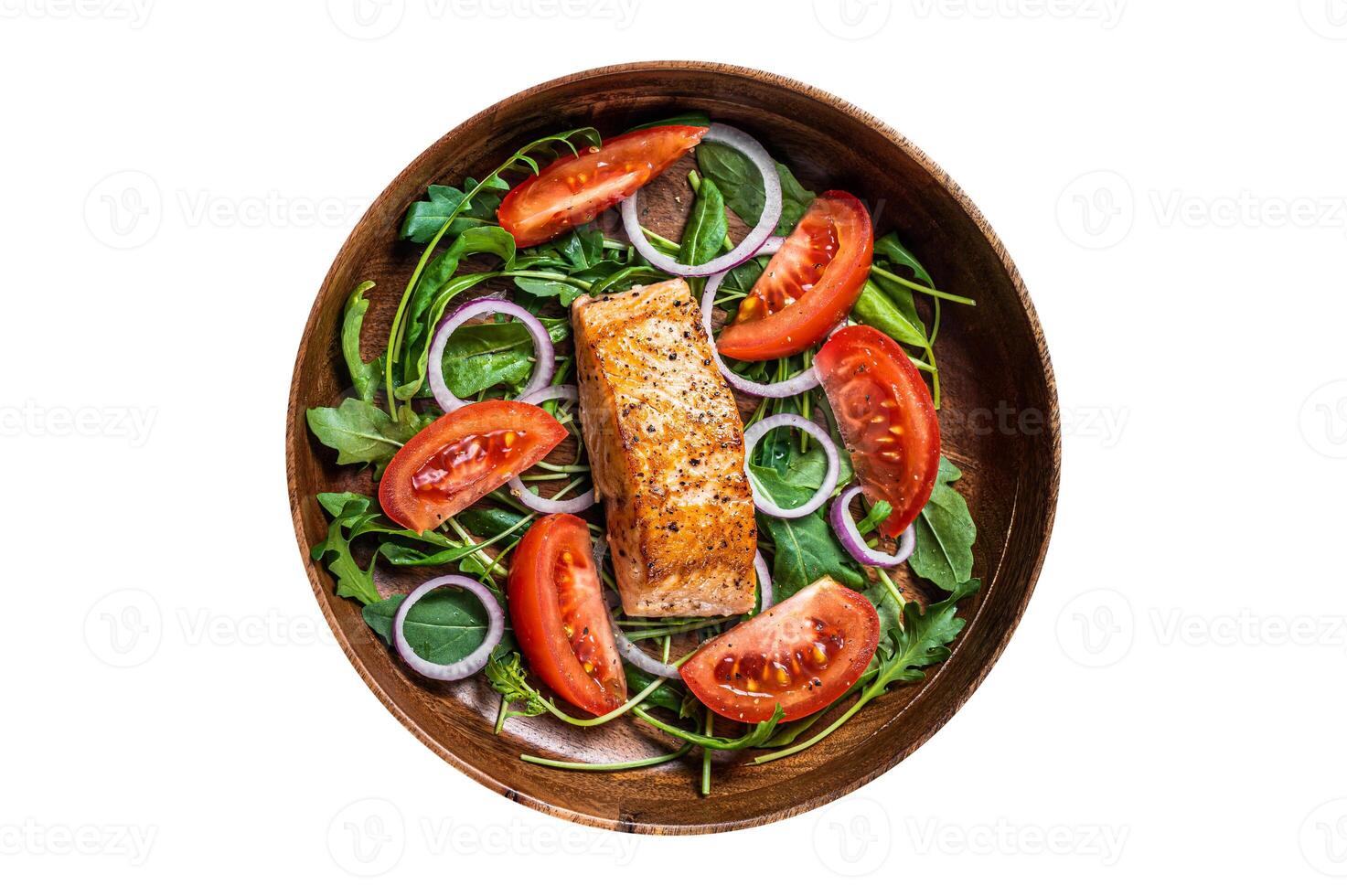 Salmon fillet steak salad with green leaves arugula, avocado and tomato in a wooden plate. Isolated, white background. Top view. photo