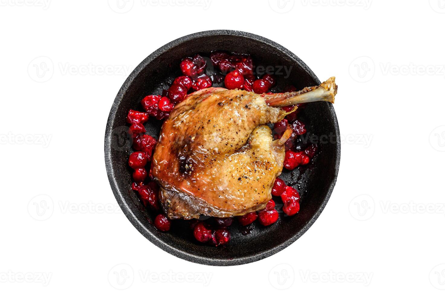 Fried duck leg with cranberrie sauce in a pan. Isolated, white background. Top view. photo