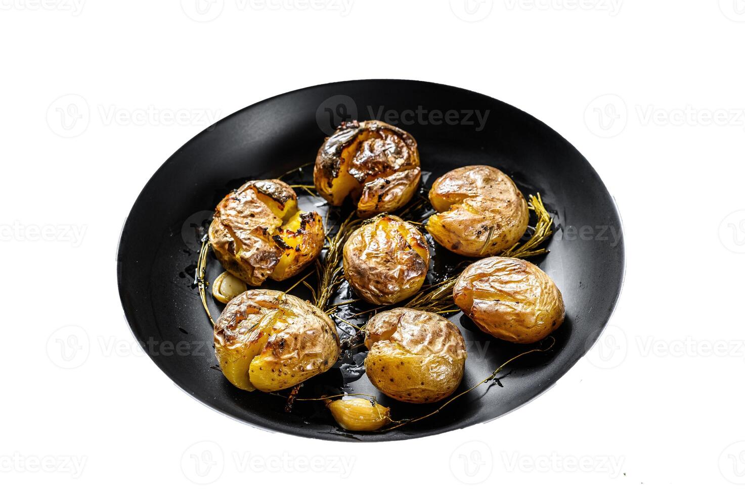 Rustic oven baked baby potatoes with rosemary. Isolated on white background. Top view. photo