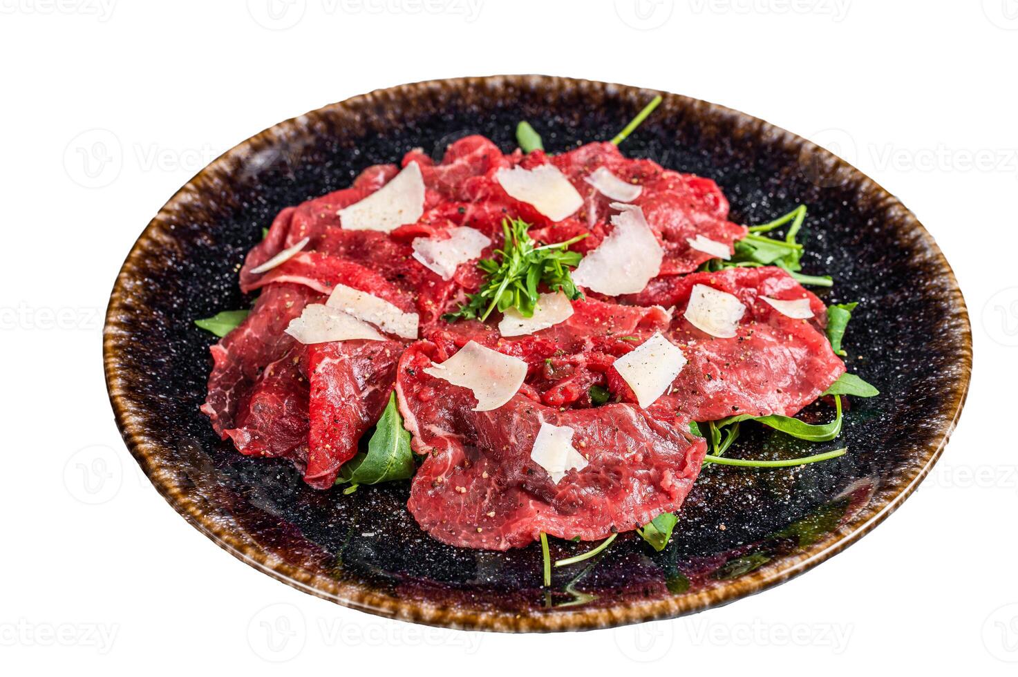 Delicious veal carpaccio with Parmesan cheese, spices and herbs. Isolated on white background. photo