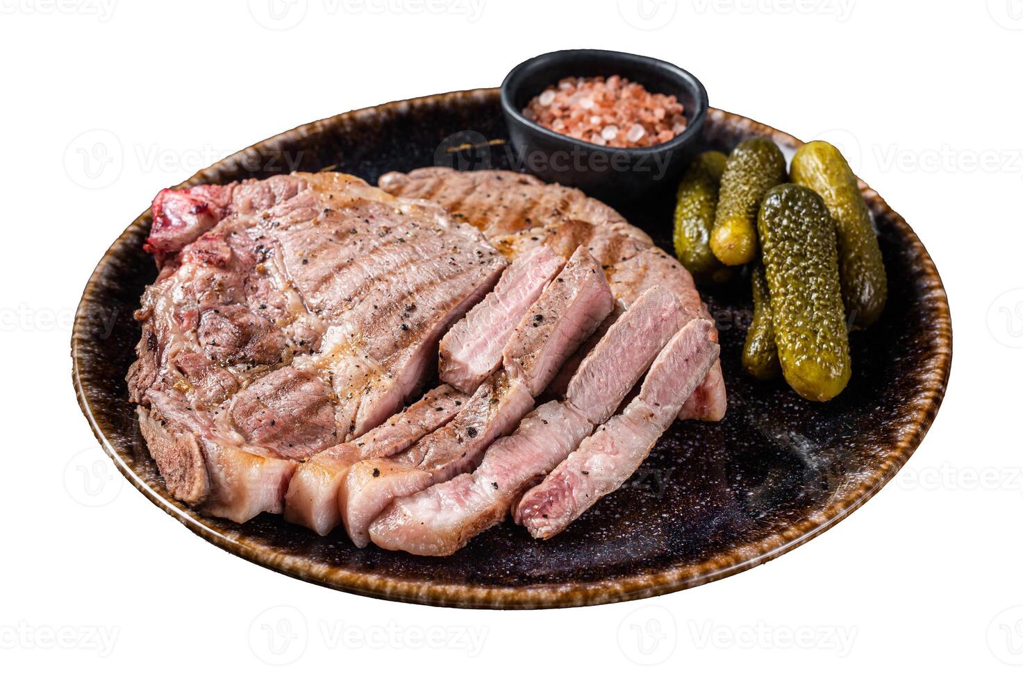 Grilled meat - Pork steaks from neck fillet meat in plate with pickled cucumbers. Isolated on white background. Top view. photo