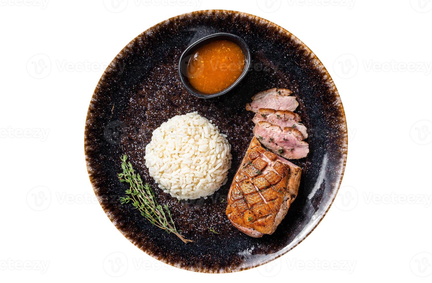 Roasted Duck breast steak, poultry fillet meat with sauce and rice. Isolated, white background. Top view. photo