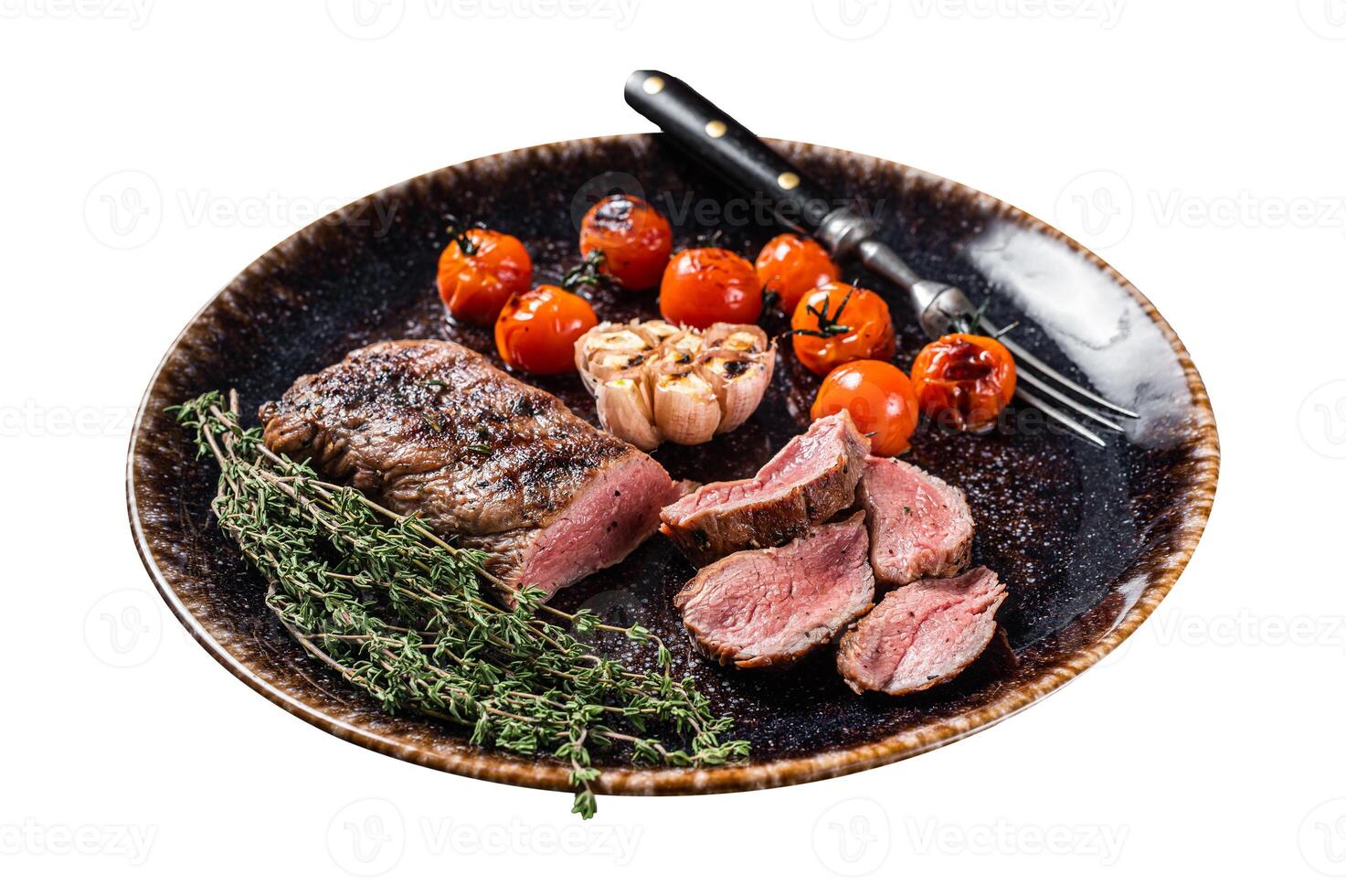 Lamb sirloin fillet meat in plate with grilled tomato, mutton grilled loin steak. Isolated on white background. Top view. photo