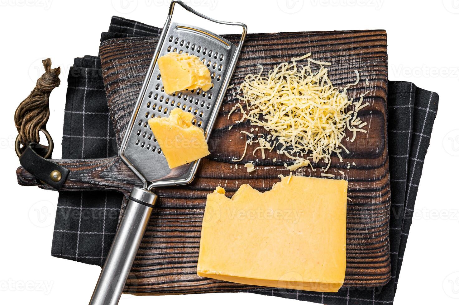 Grated cheddar cheese piece on a wooden board. Isolated on white background, top view. photo