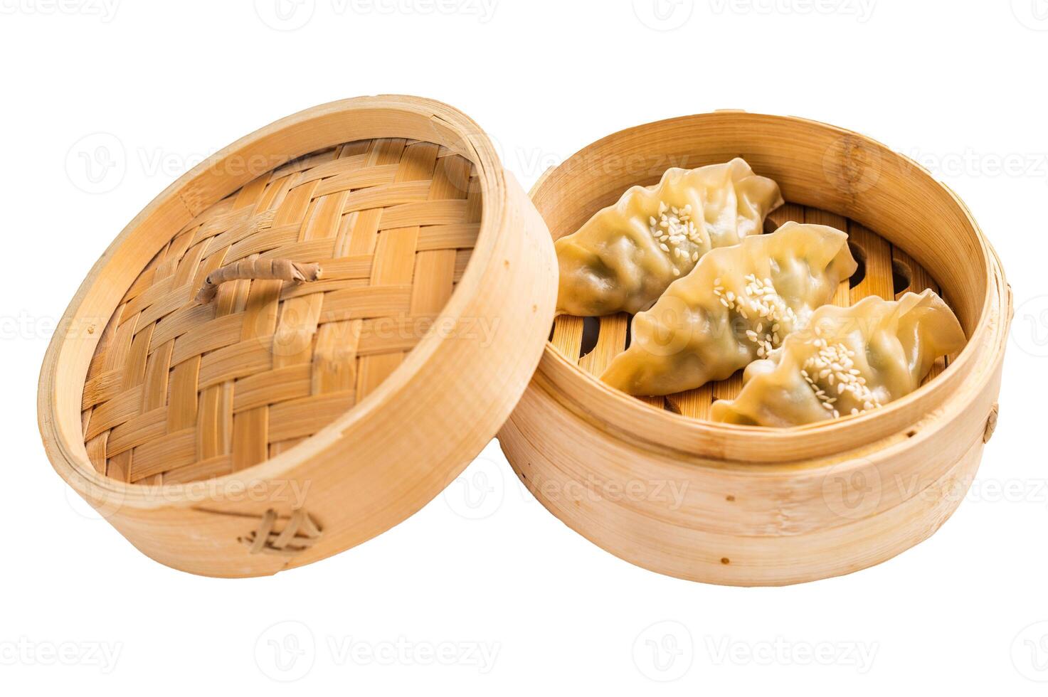 Steamed Japanese Gyoza Dumplings with pork meat and vegetables in bamboo steamer isolated on white background. top view photo
