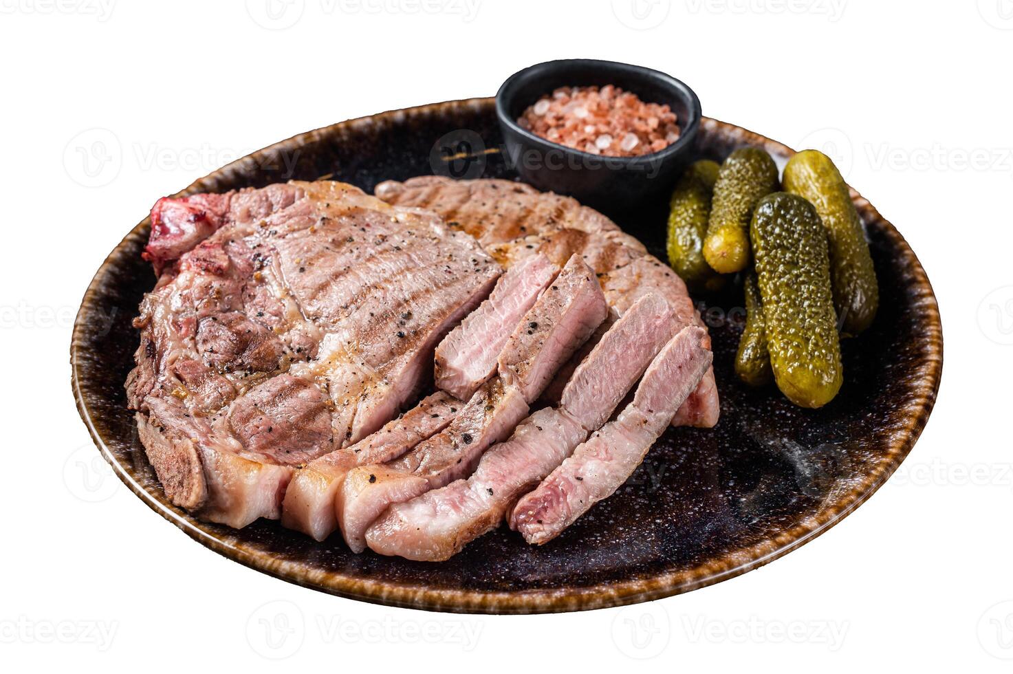 Grilled meat - Pork steaks from neck fillet meat in plate with pickled cucumbers. Isolated on white background. photo