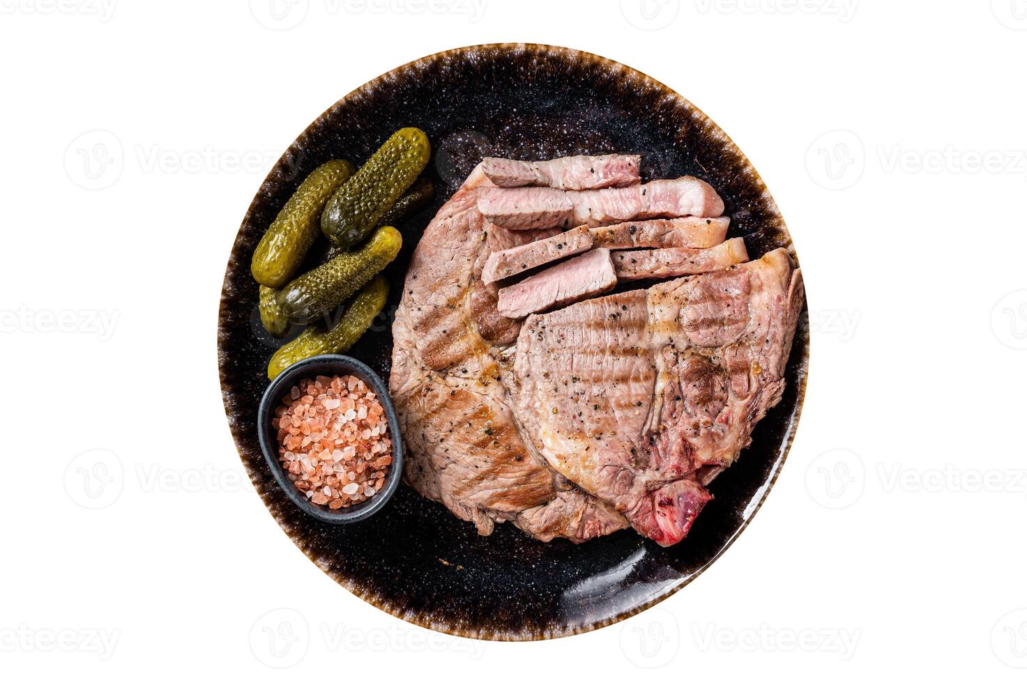 Grilled meat - Pork steaks from neck fillet meat in plate with pickled cucumbers. Isolated on white background. photo