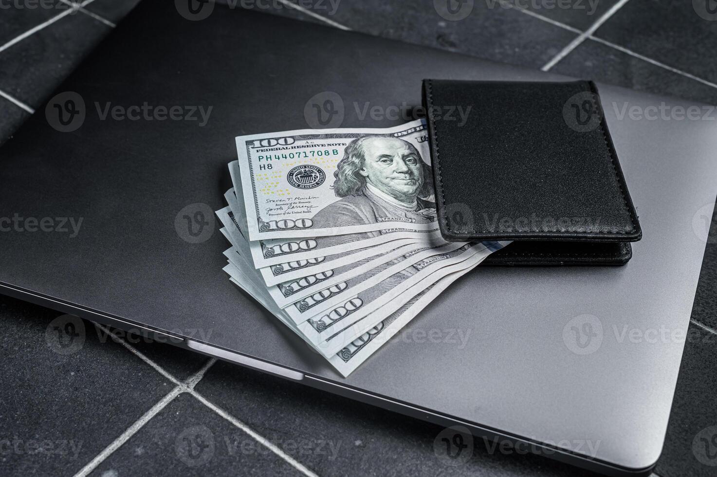Corporate business desktop with laptop, digital tablet, wallet, money and cup of coffee. Black background. Top view. Copy space photo