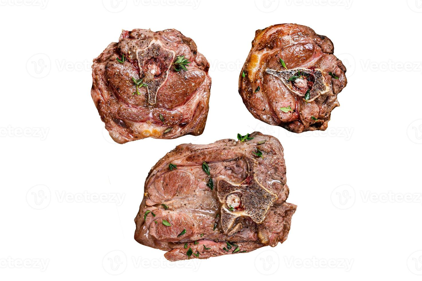 Fried lamb neck meat steaks in a wooden plate with herbs. Isolated on white background, top view. photo