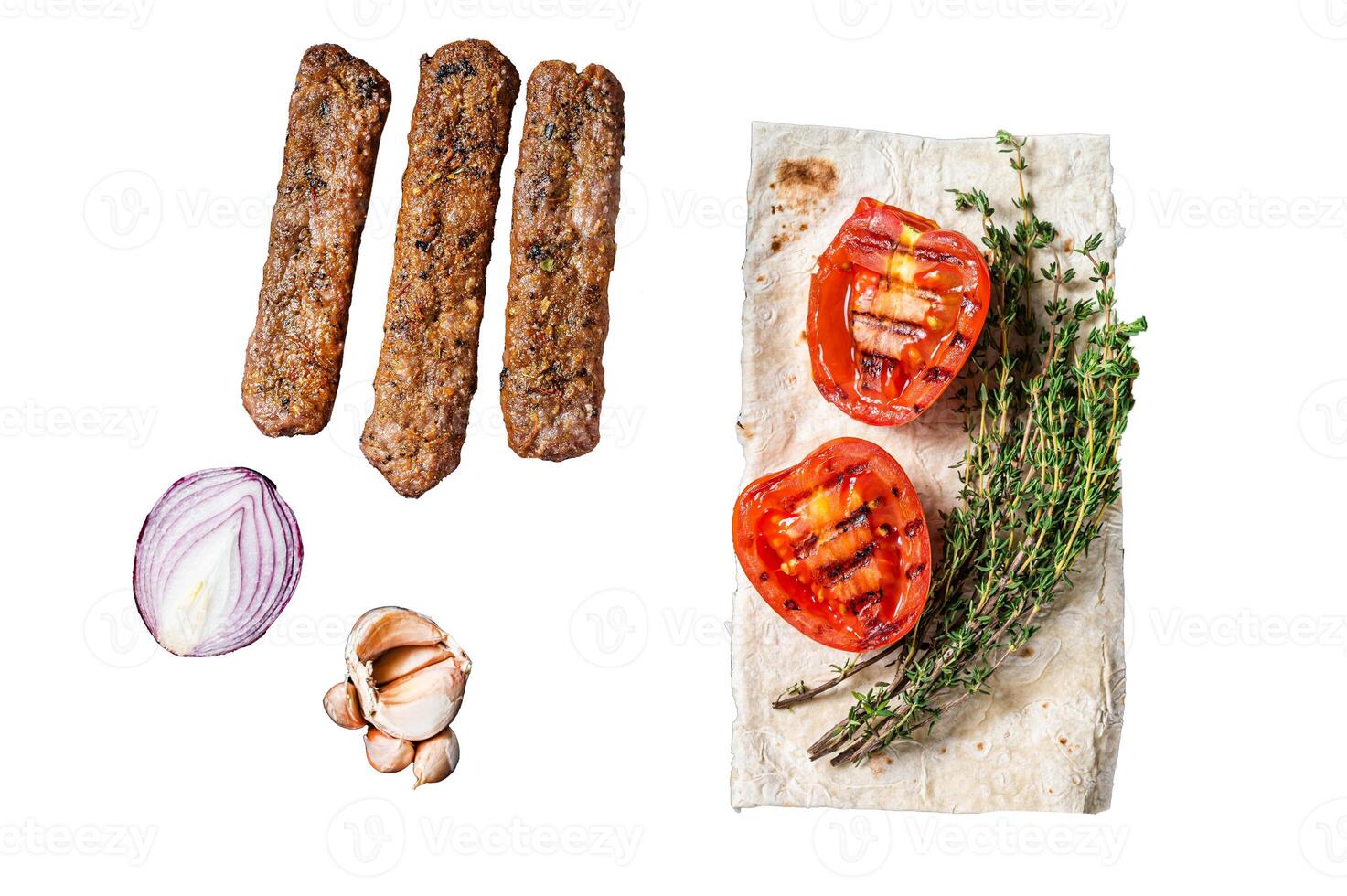 BBQ adana shish kebab on a grill with bread and tomato. Isolated on white background, top view. photo