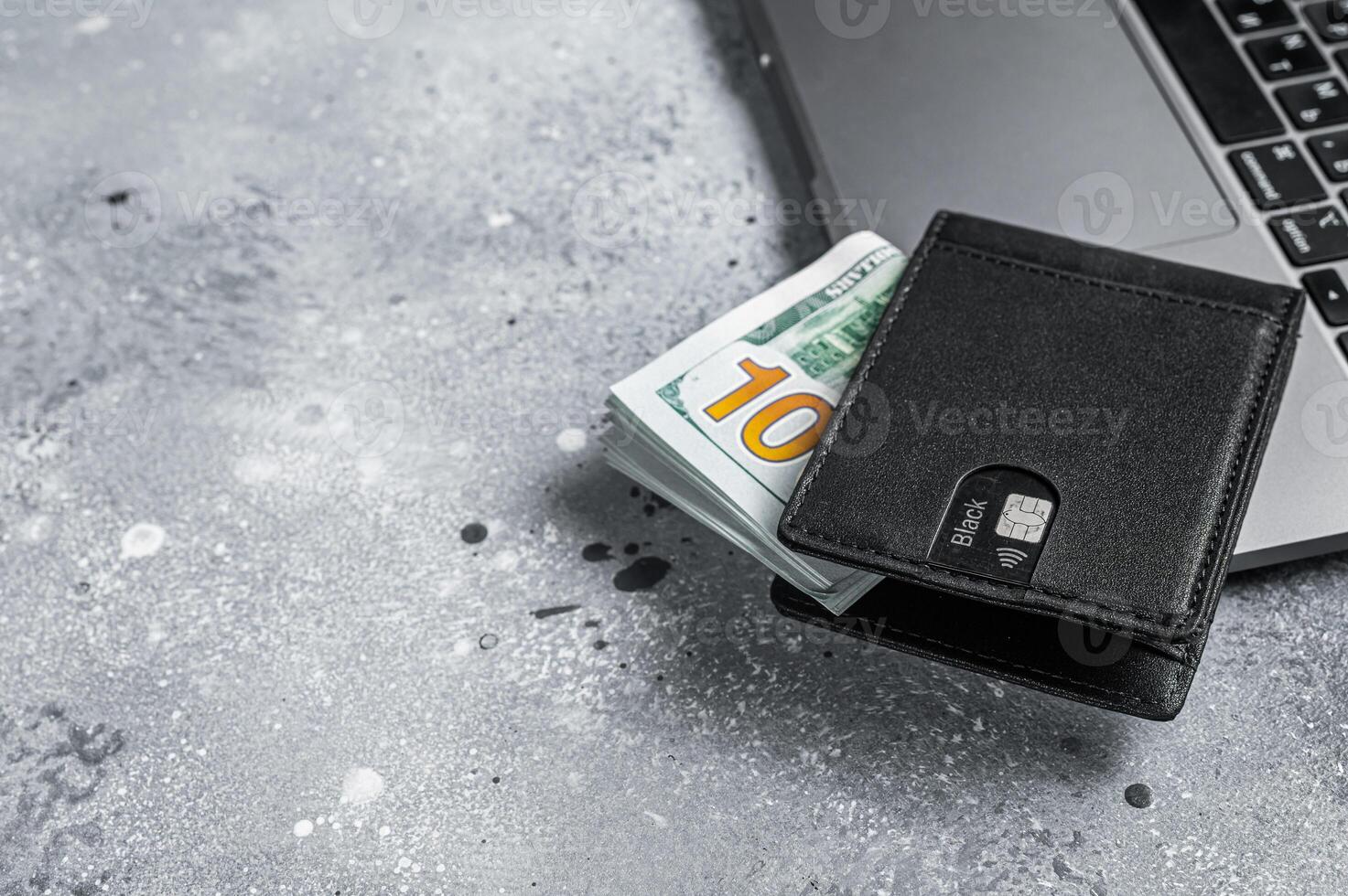 Workplace with stylish leather wallet with money, Laptop. Gray background. Top view. Copy space photo