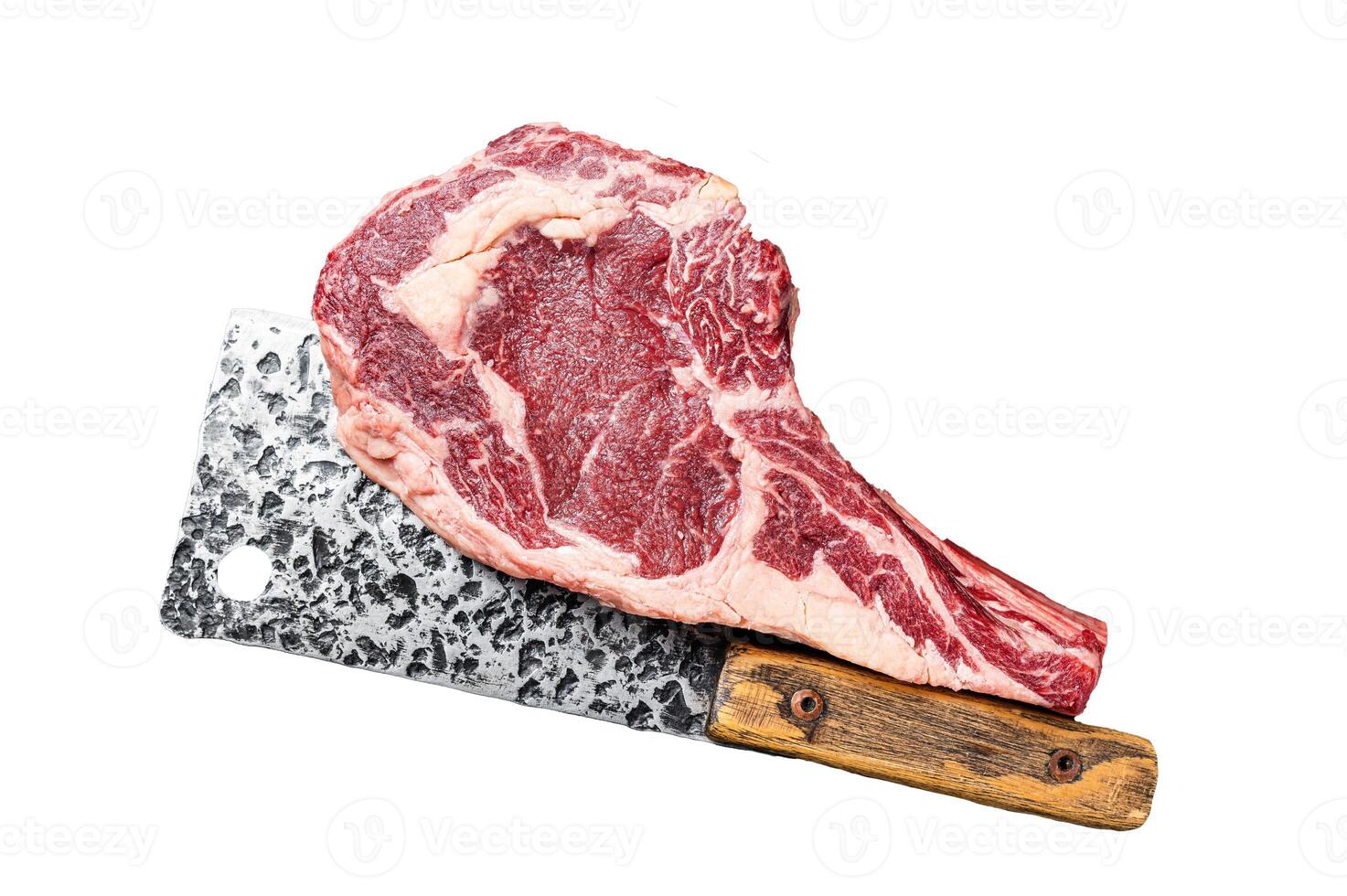 Dry aged Tomahawk rib eye steak, raw beef meat on butcher table. Isolated, white background. photo