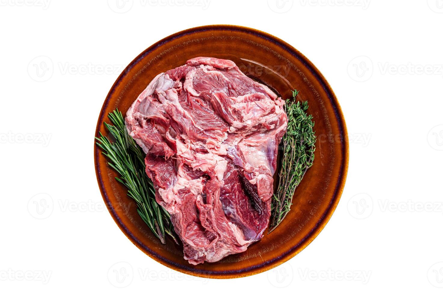 Raw Boneless Lamb leg meat in rustic plate with thyme. Isolated, white background. Top view. photo