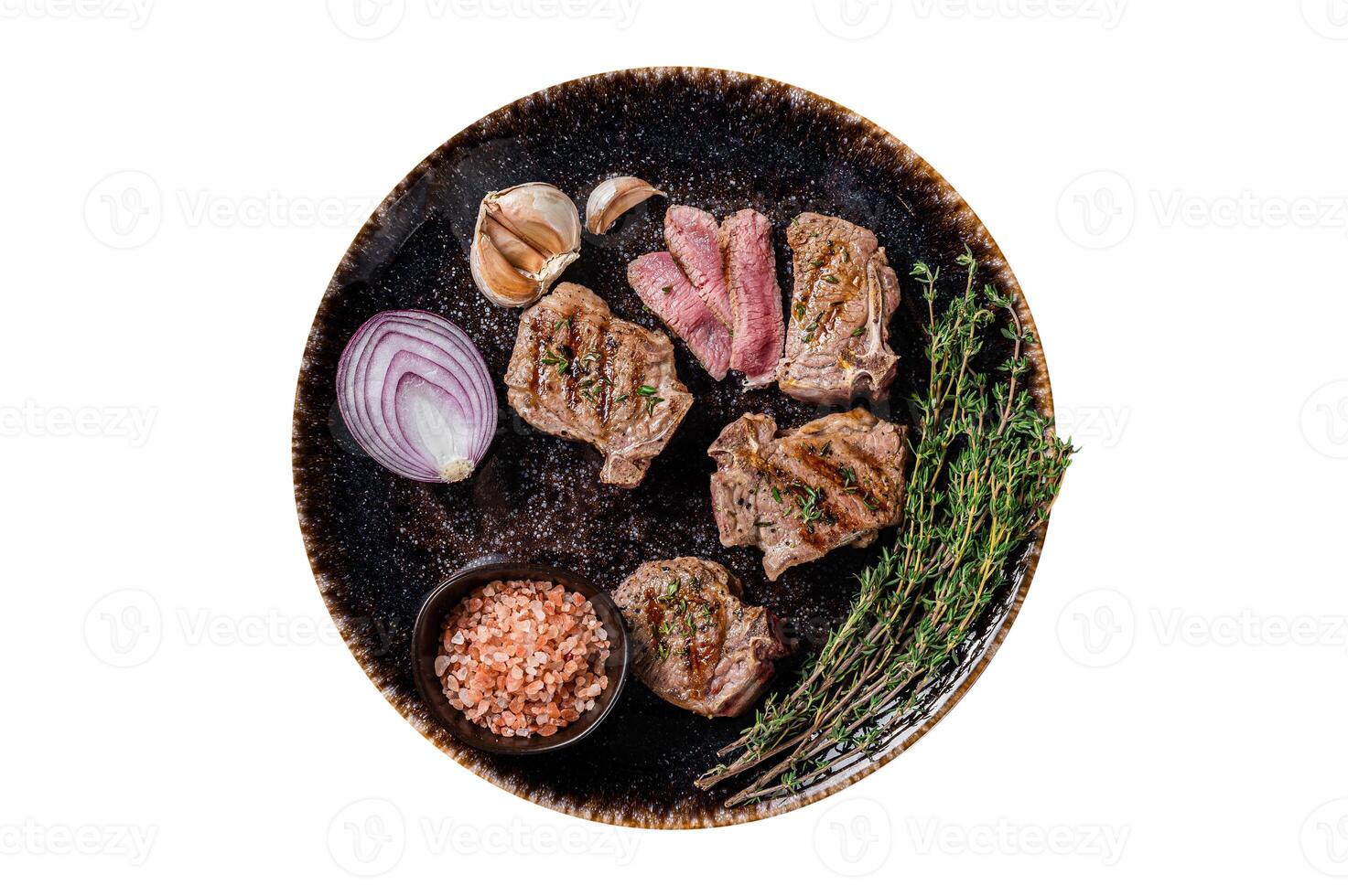 Barbecue Grilled lamb loin chops steaks, saddle in a plate with herbs. Isolated, white background. Top view. photo