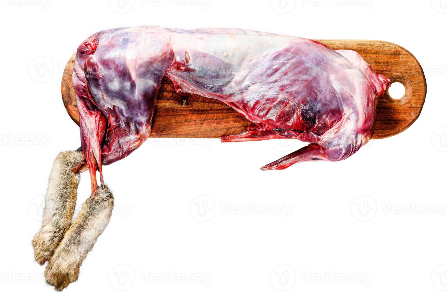 Whole forest wild hare, raw meat on wooden deck, old black rustic table. Isolated on white background. Top view. photo