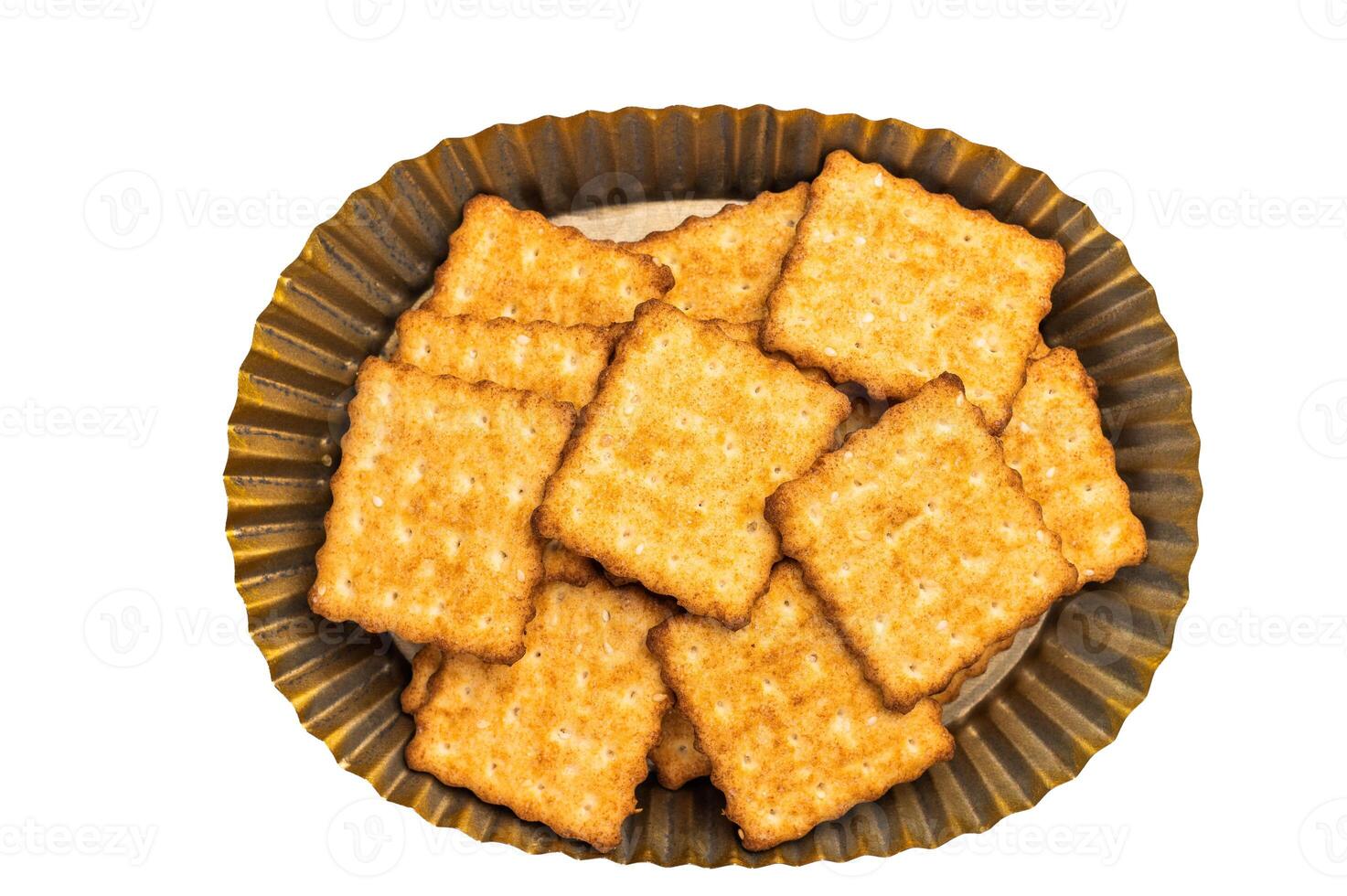 Heap of square Wholemeal salt crackers isolated on white background, top view. photo