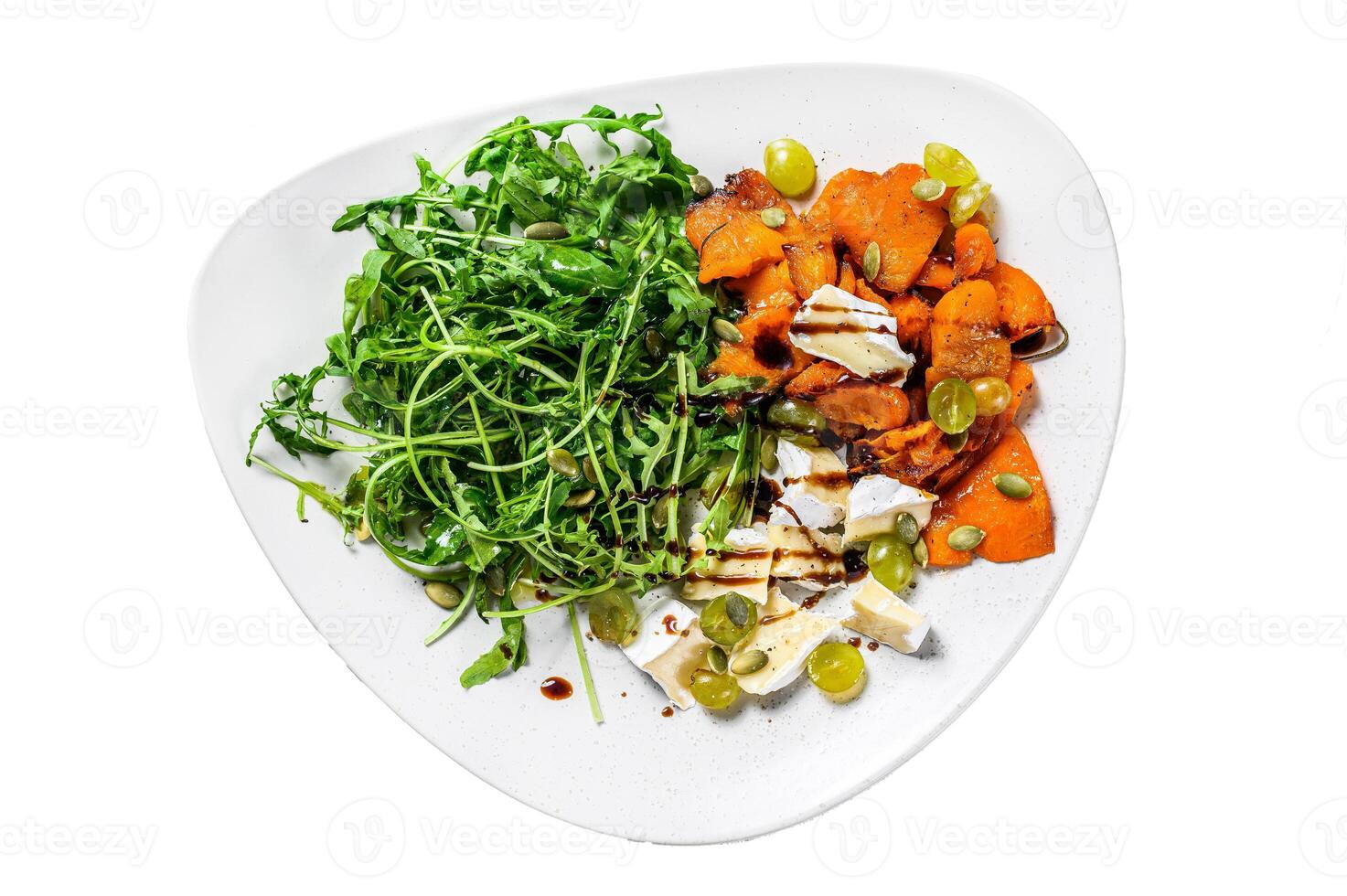 Salad with arugula, baked pumpkin and brie cheese. Isolated on white background, Top view. photo