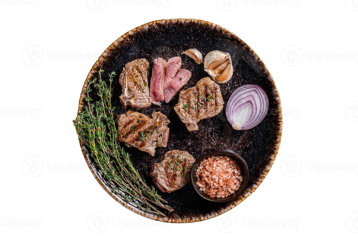 Barbecue Grilled lamb loin chops steaks, saddle in a plate with herbs. Isolated on white background. photo