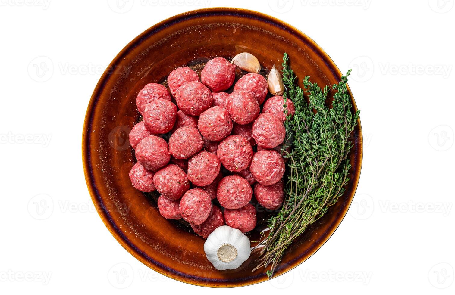Raw meatballs from mince lamb mutton meat with thyme on rustic plate. Isolated, white background. Top view. photo