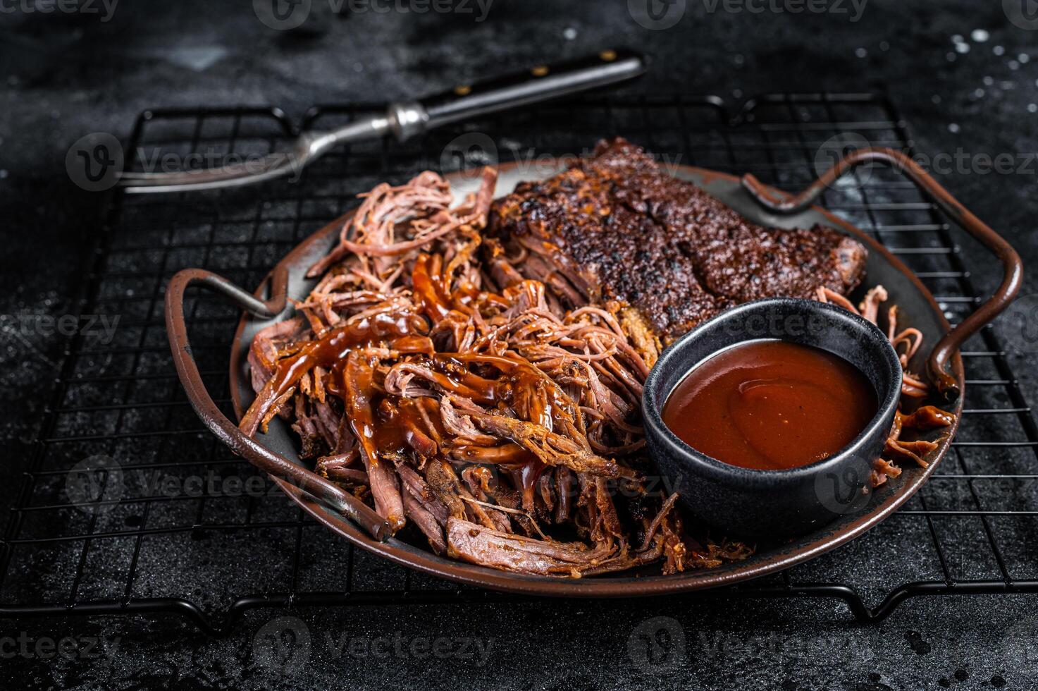 Slow Cooked Pulled Beef, Traditional meat rubbed with spices and smoked in a Texas smoker. Black background. Top view photo