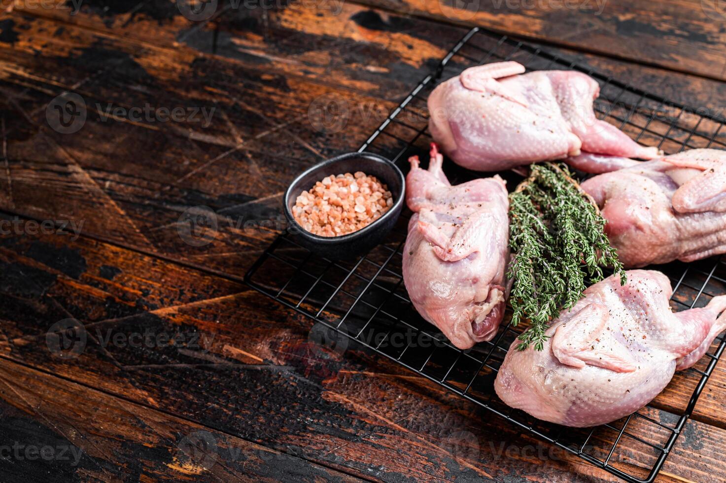 Farm eco friendly raw quails on kitchen table. Wooden background. Top view. Copy space photo