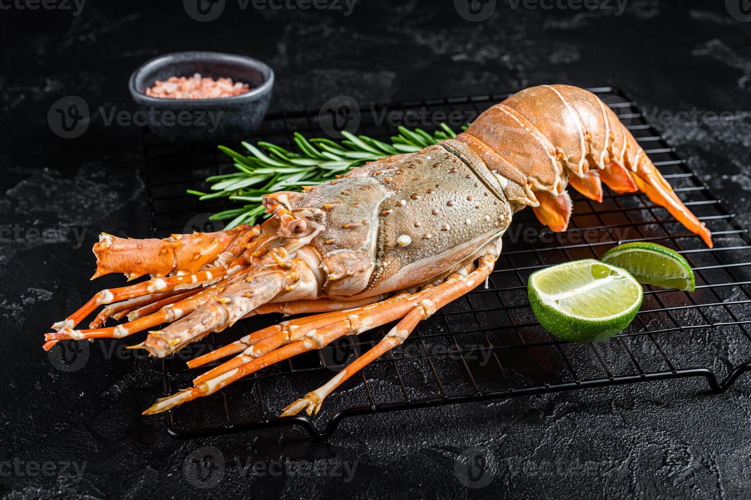 Boiled Spiny lobster or sea crayfish ready for eat. Black background. Top view photo