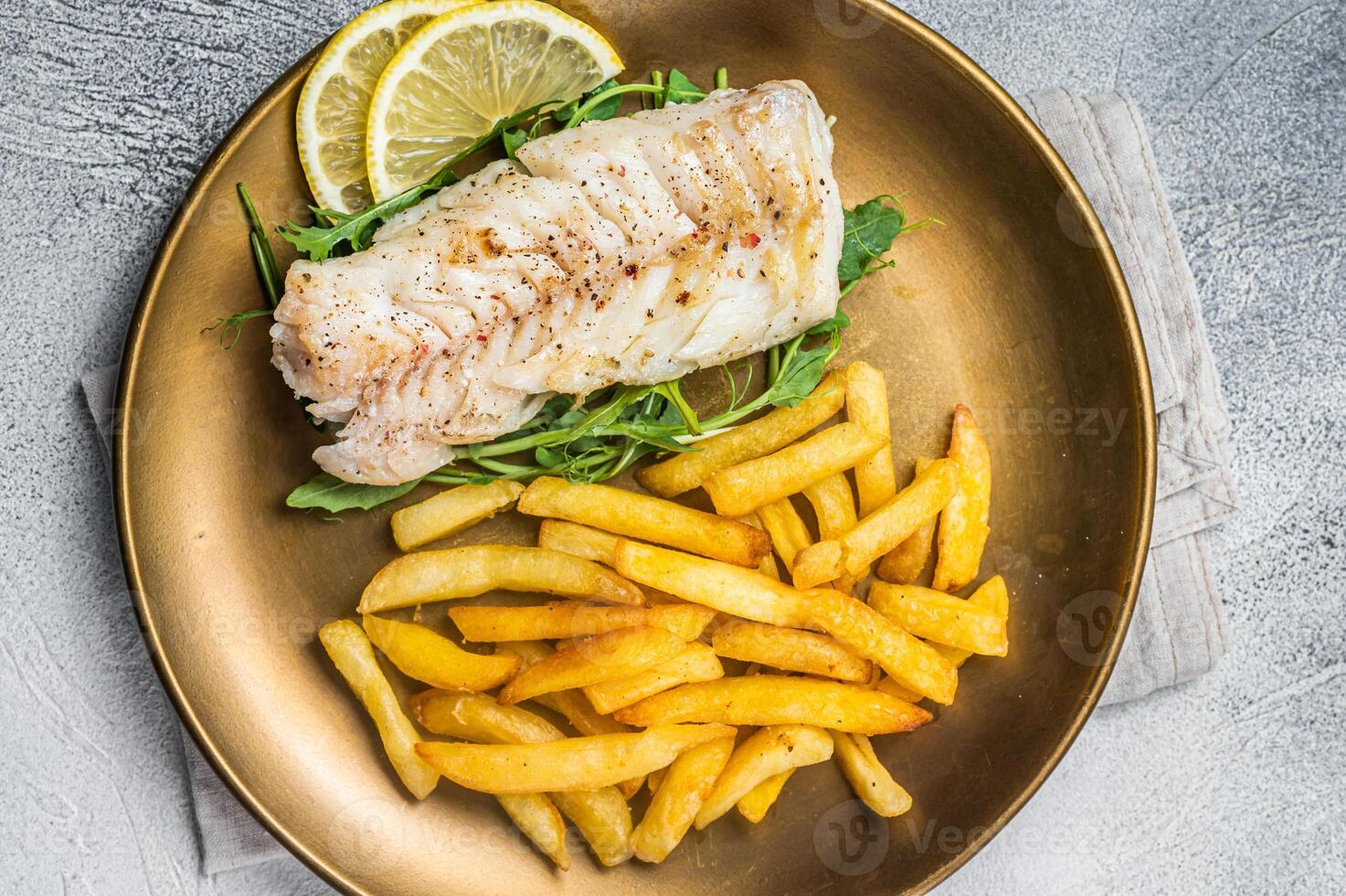 Fried cod fish fillet served with french fries. White background. Top view photo