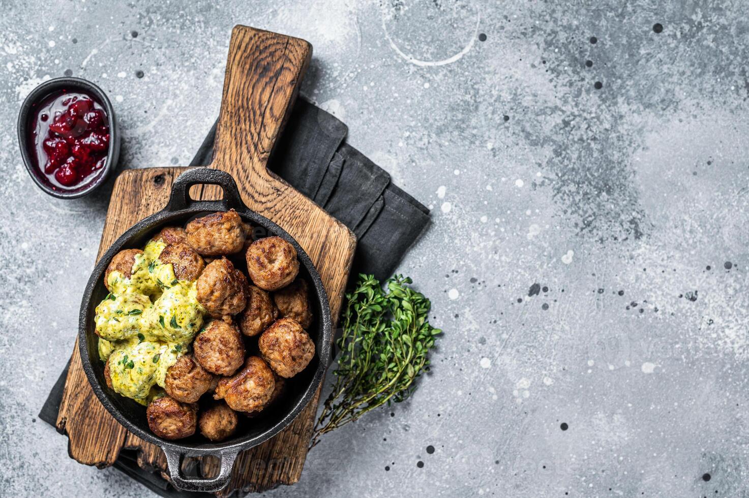 Swedish Meatballs with Cream Sauce in a skillet. Gray background. Top view. Copy space photo