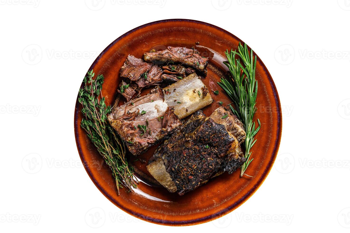 Grilled short beef ribs with thyme on a rustic plate. High quality Isolate, white background. photo