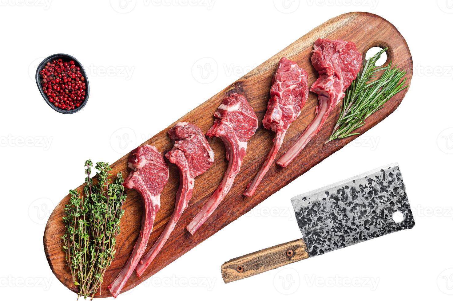 Raw Lamb chop steak on butcher board with rosemary and thyme. Isolated, white background. photo