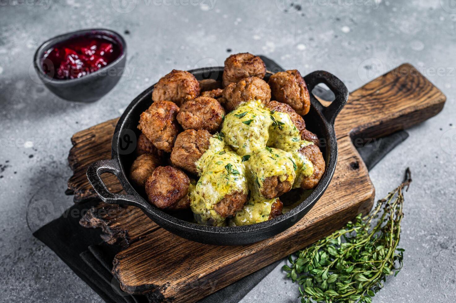 Swedish Meatballs with Cream Sauce in a skillet. Gray background. Top view photo
