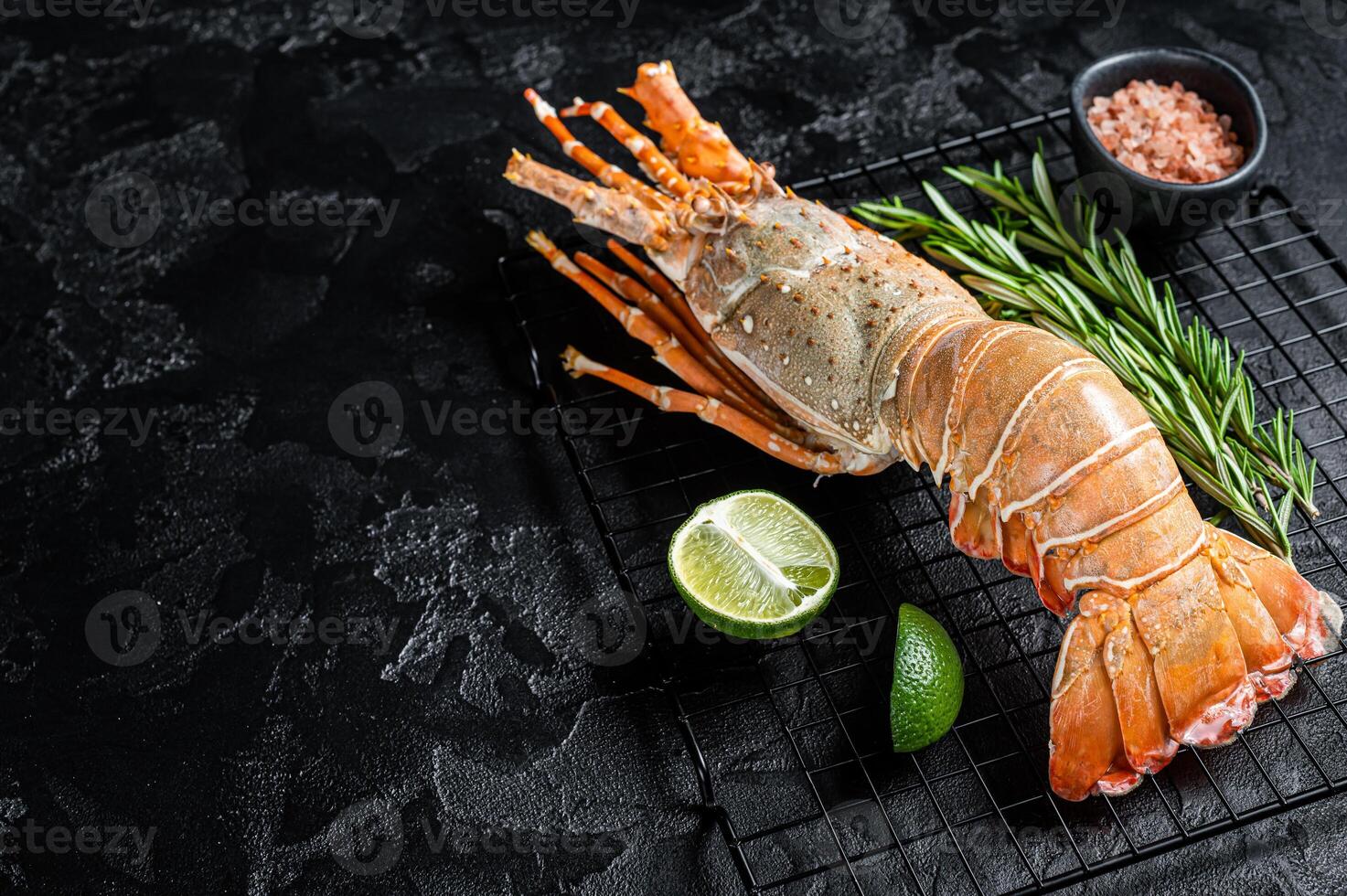 Boiled Spiny lobster or sea crayfish ready for eat. Black background. Top view. Copy space photo