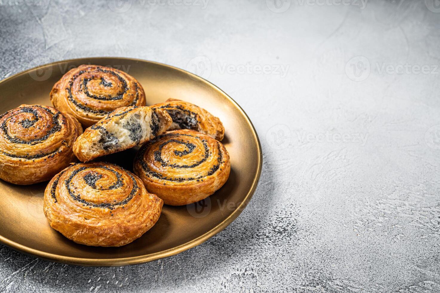 Poppy seed rolls and cardamom buns, Traditional Nordic baked sweet breads on wooden board. White background. Top view. Copy space photo