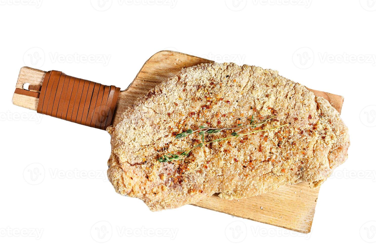 Raw chicken schnitzel in breadcrumbs. Isolated on white background. Top view. photo