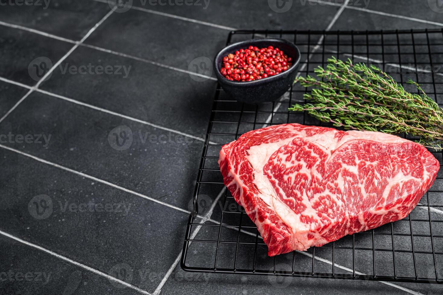 Uncooked wagyu Rib Eye steak, raw beef meat. Black background. Top view. Copy space photo