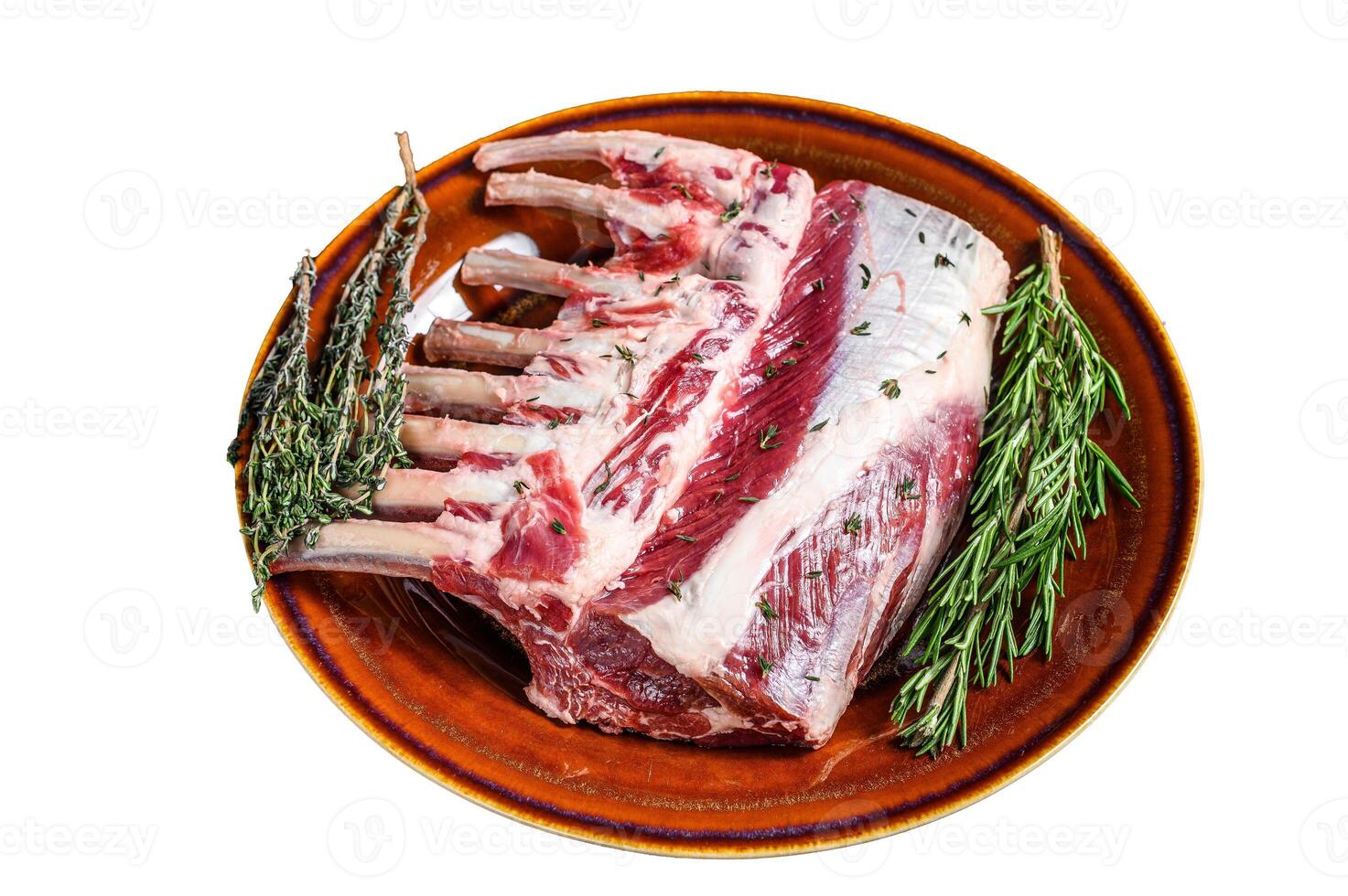 Raw fresh rack of lamb with green herbs. Isolated on white background. photo