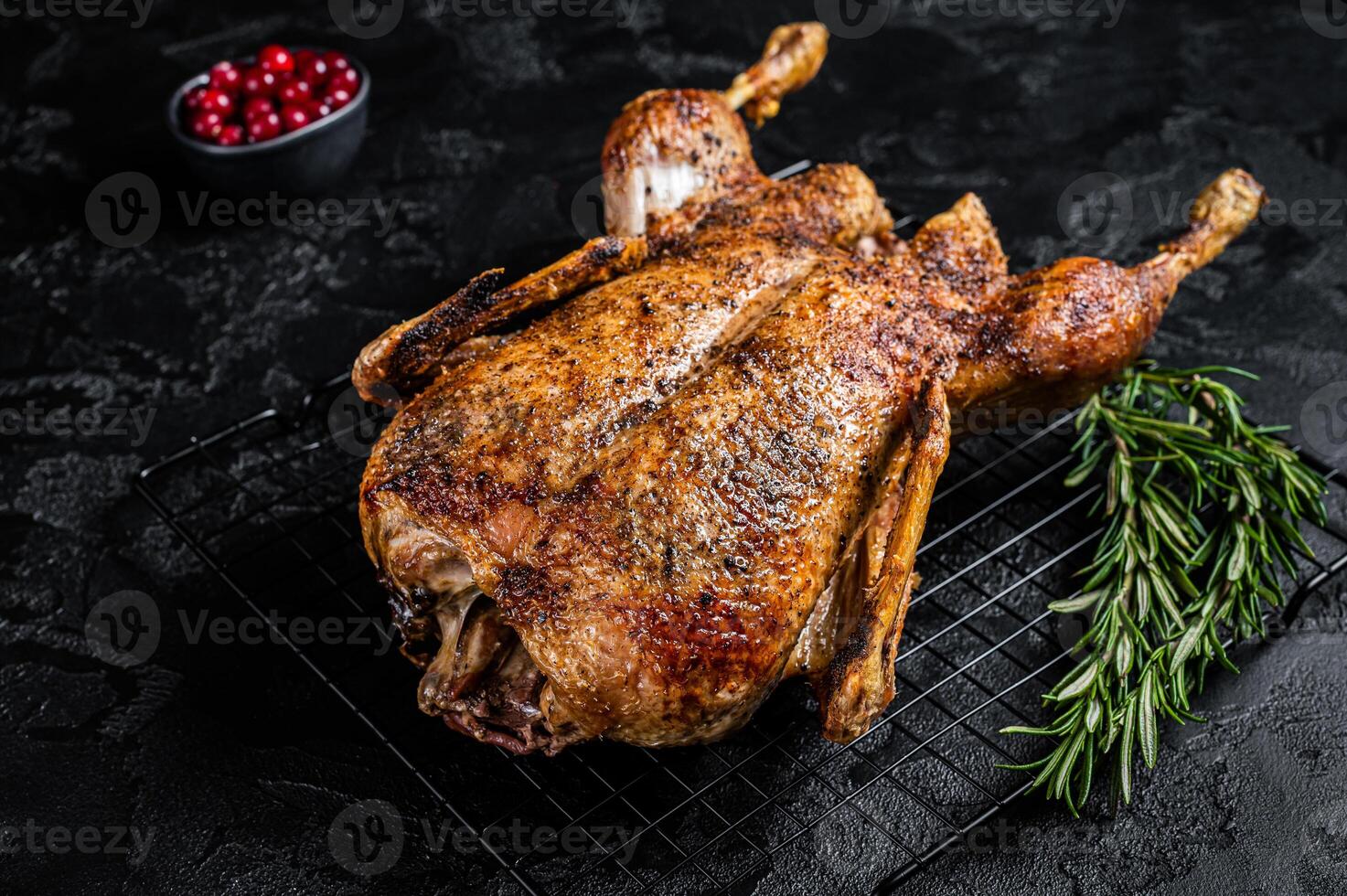 Roast whole duck, festive christmas recipe. Black background. Top view photo