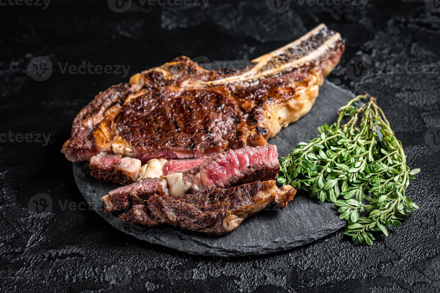 Roasted Tomahawk or cowboy with bone beef meat steak. Black background. Top view photo