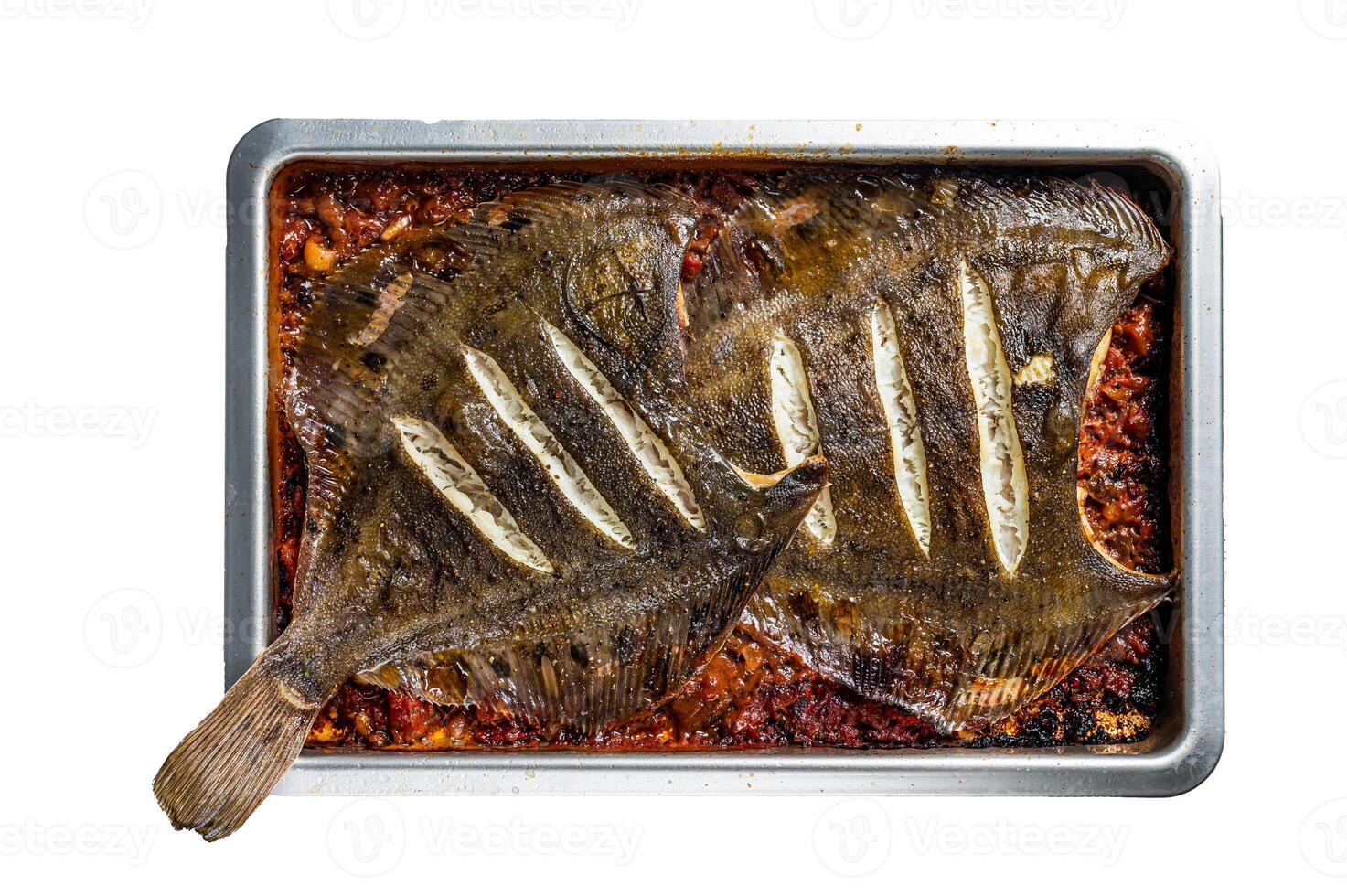 Flounder flat fish roasted in a tomato sauce in baking tray. Isolated background photo