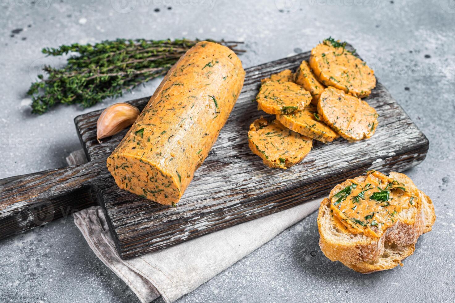 Herb Butter with Chives, Basil, Oregano, Parsley and garlic. Gray background. Top view photo