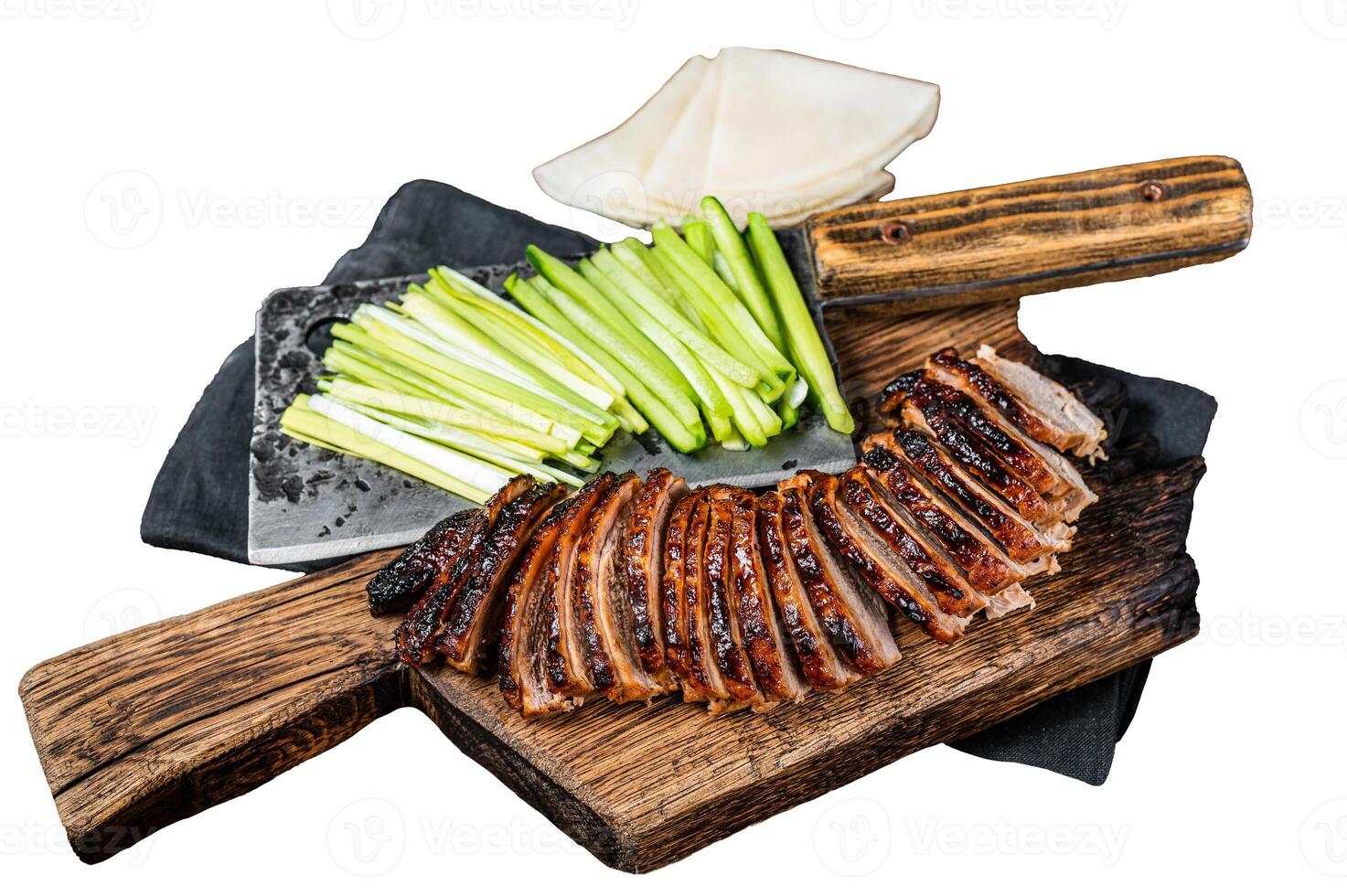 Sliced Peking Duck served with cucumber, green onion, and wheaten chinese pancakes on a meat cleaver Isolated, white background. photo