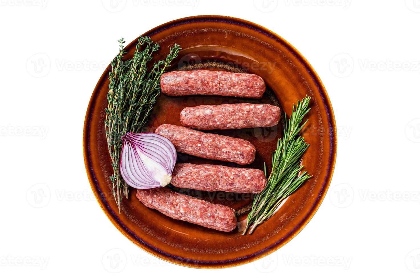 Raw kofta meat kebabs sausages on a plate with herbs. Isolated, white background. Top view. photo