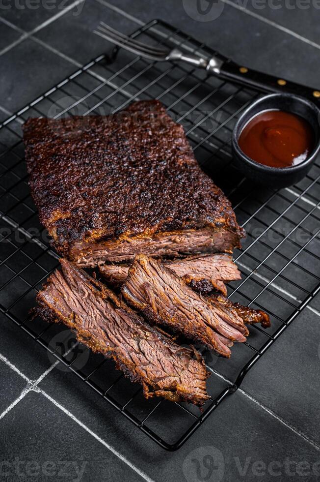Chopped Beef Brisket barbecue, Traditional meat rubbed with spices and smoked in a Texas smoker. Black background. Top view photo