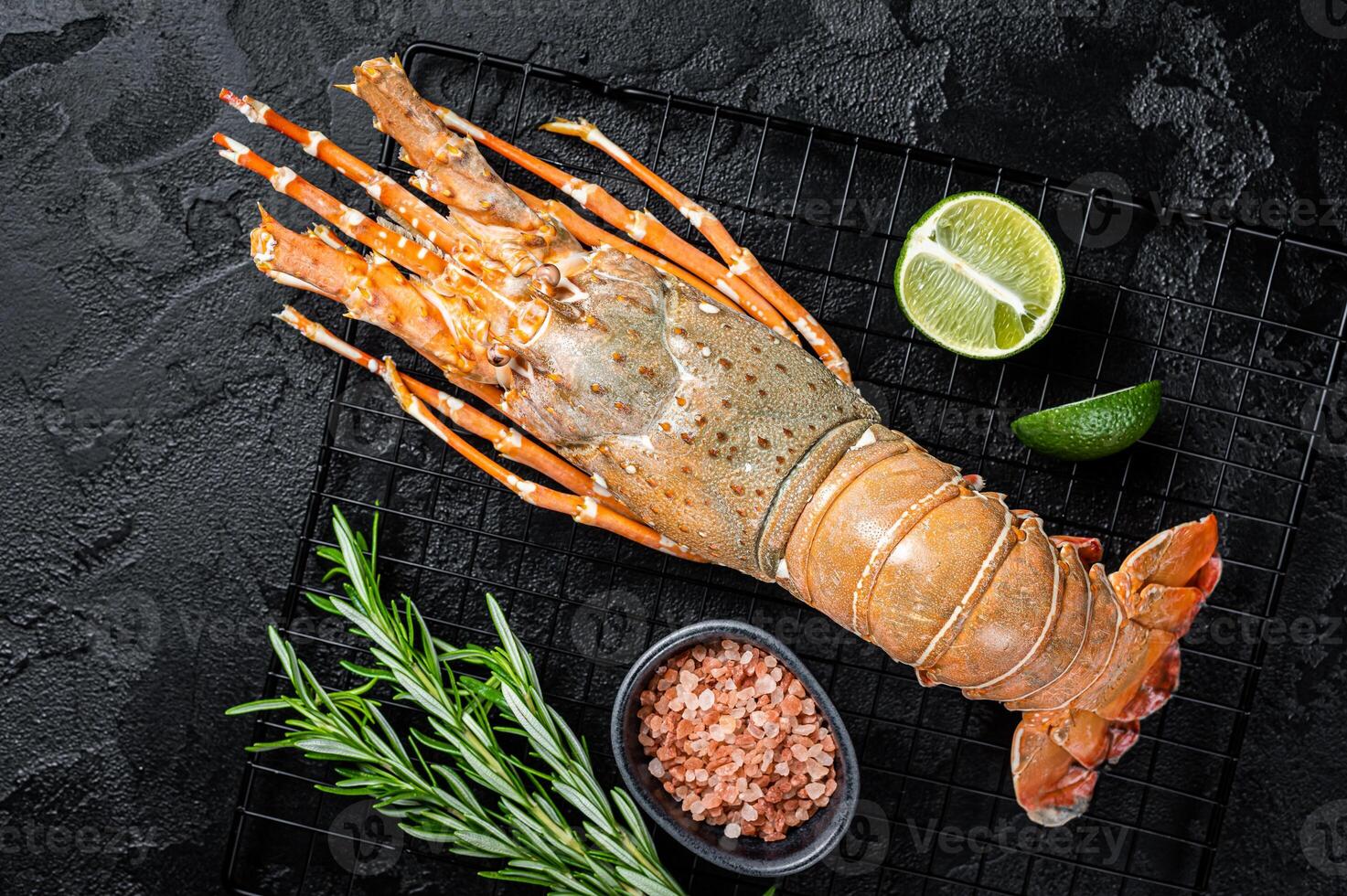 Boiled Spiny lobster or sea crayfish ready for eat. Black background. Top view photo