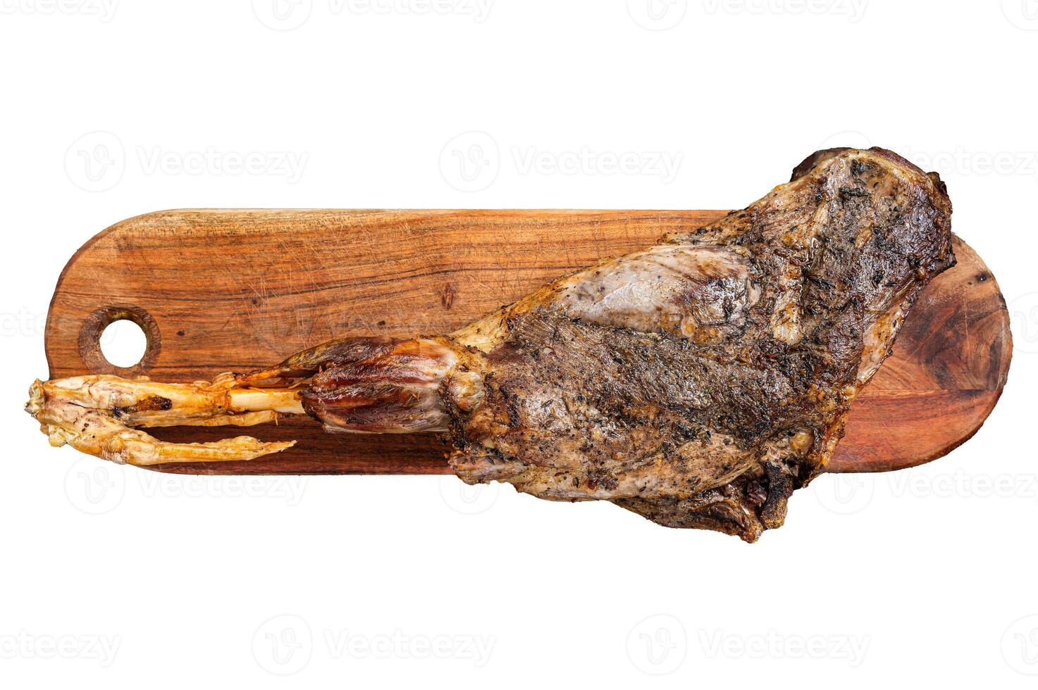 Roast lamb leg meat with herbs and spices on a cutting board. Isolated, white background. photo